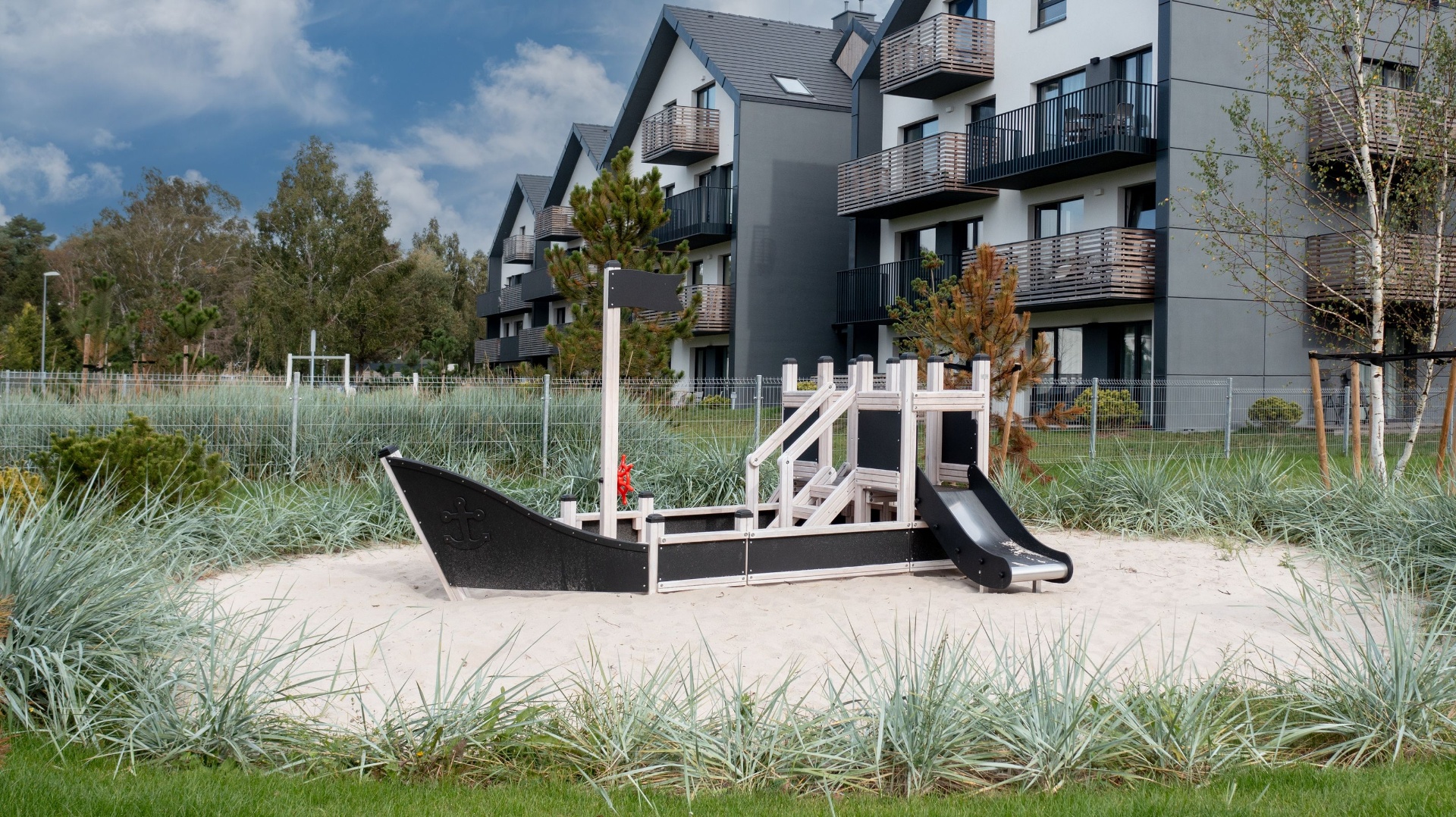 Outdoor playground equipment for a residential family area — themed structure on sand